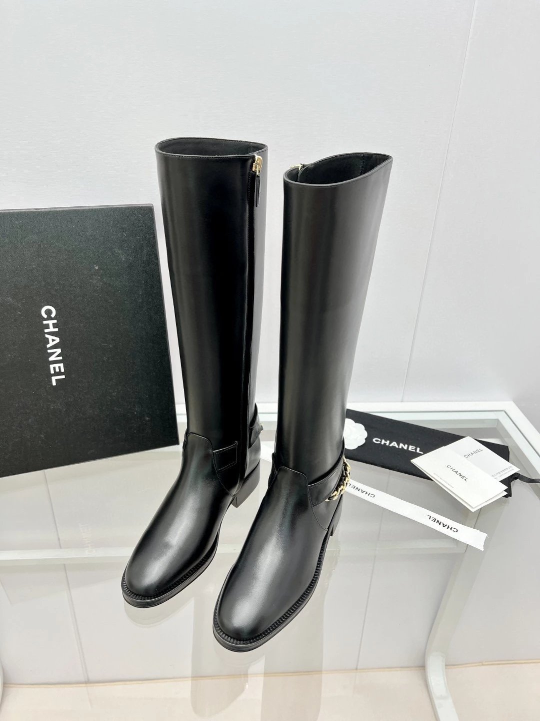 CHANEL riding boots with CC and chain at back